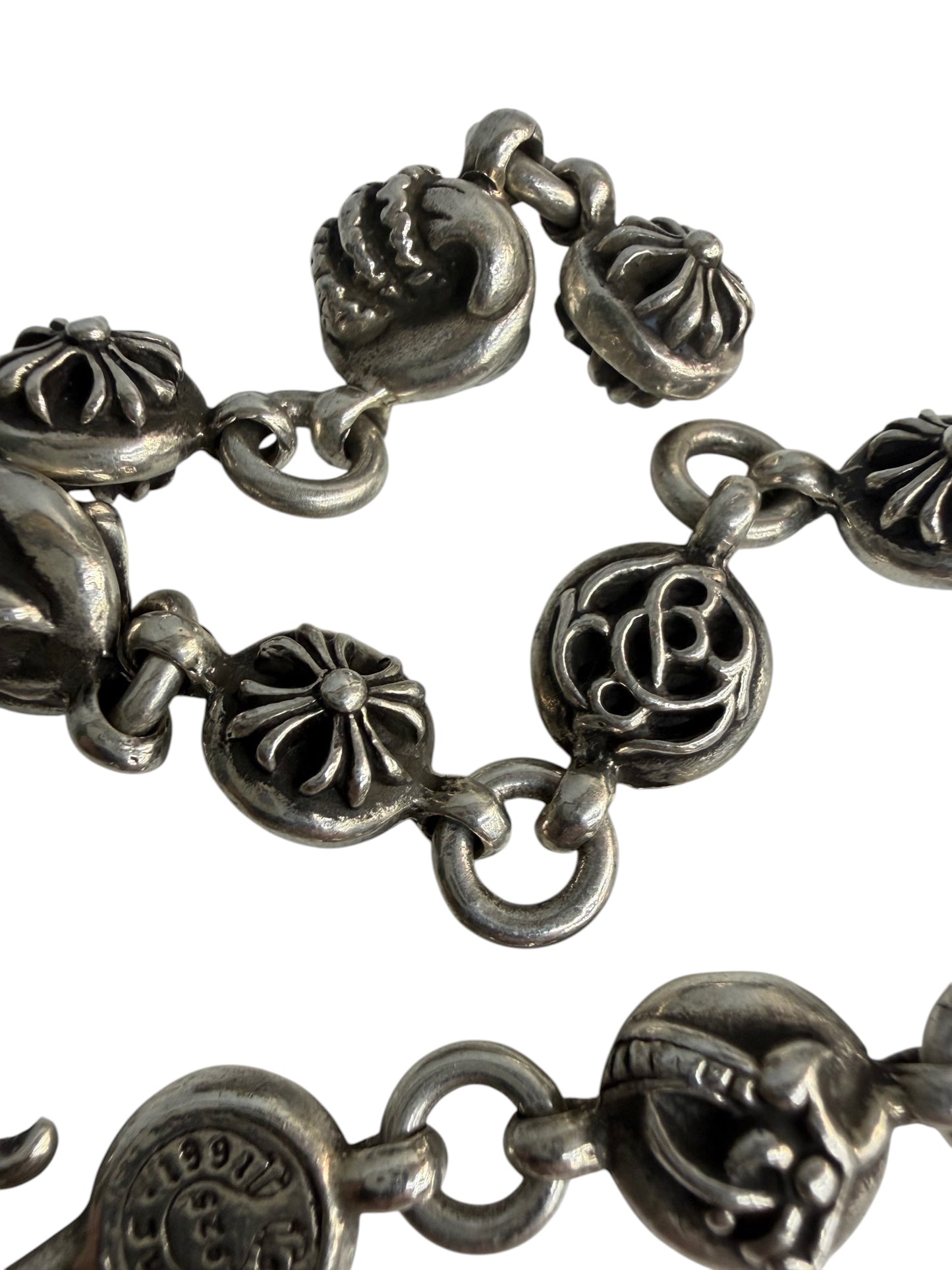 Performa Chrome Hearts sterling silver link bracelet featuring oxidized circular charms with intricate cross motifs.